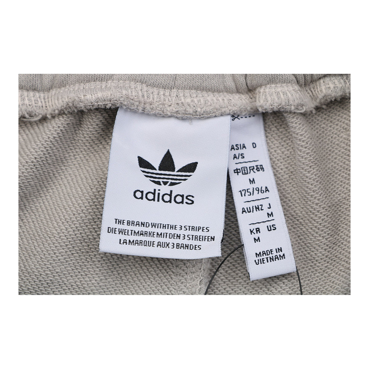 Calça Adidas Originals Trefoil Cinza-Claro - etiqueta de tamanho e marca